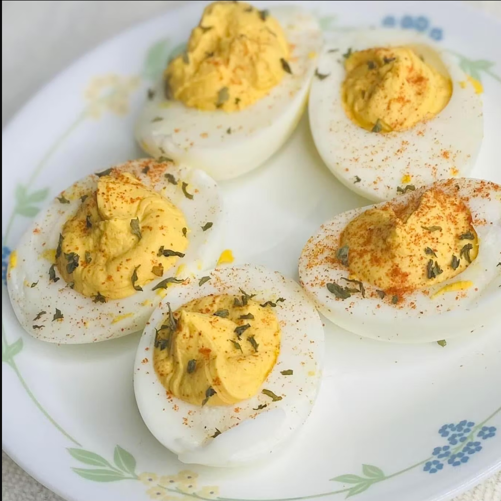 Deviled eggs on a decorative plate with a floral pattern